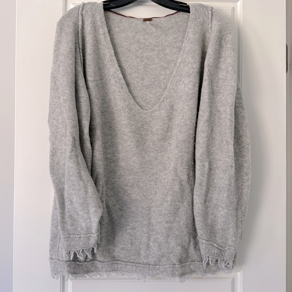Free People cozy grey sweater with frayed edges